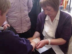 Nurse Jean applying a dressing. 